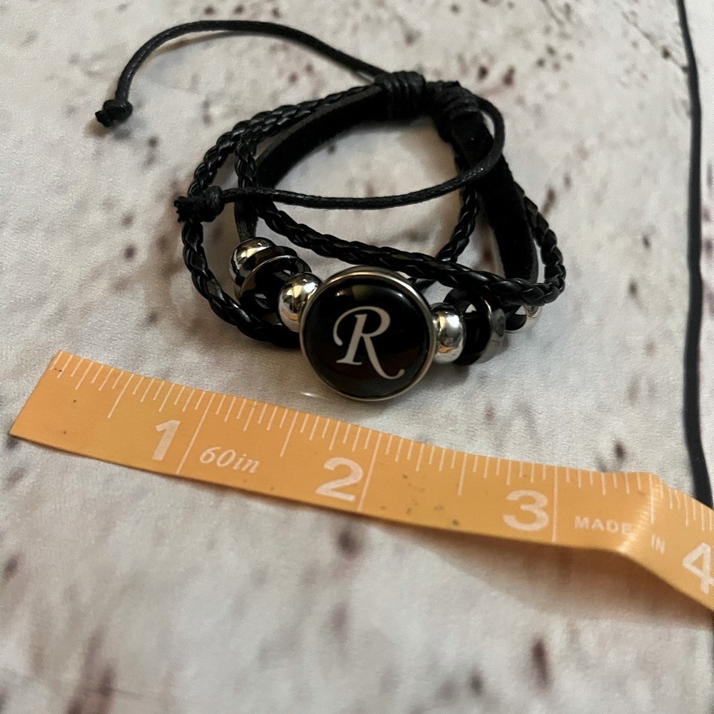 Brand new adjustable braided strappy black R bracelet